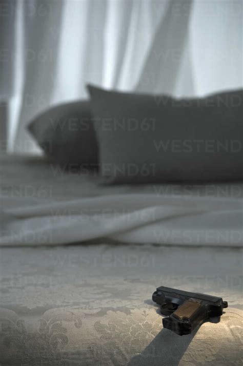 Pistol An Bed Stock Photo