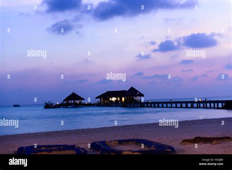 Island in ocean, Maldives. Sunset Stock Photo - Alamy