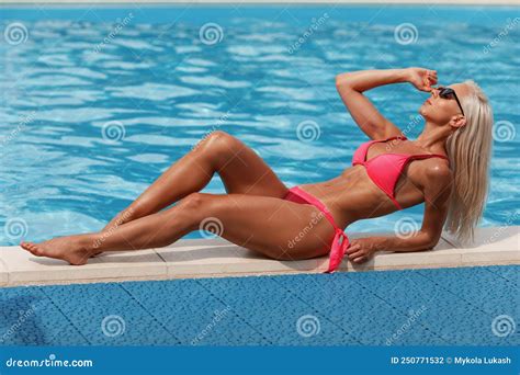 Woman In Bikini Enjoying Summer Sun And Tanning During Holidays In Pool