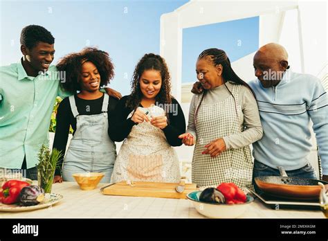 Happy african family cooking together in outdoor kitchen at home ...