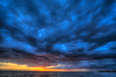 Blue Cloudy Sky with Sunset Photograph by Krzysztof Hanusiak