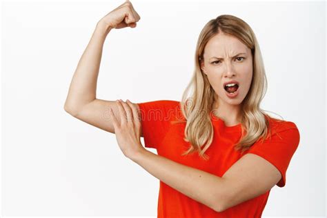 Confident And Sassy Blond Girl Showing Muscles Touching Her Arm