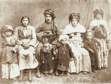 An Old Black And White Photo Of People In Native American Dress