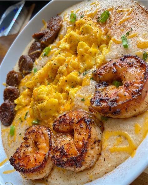 A Plate With Shrimp Scrambled Eggs And Sausage