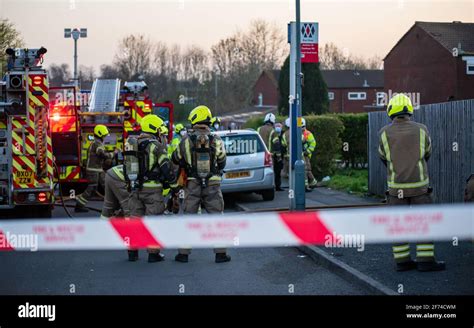 British Firefighters Standing Behind Incident Tape In Birmingham West