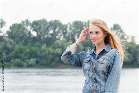 Beautiful Blonde Woman In Blue Jeans And With Long Hair On Nature Background Stock Photo Adobe