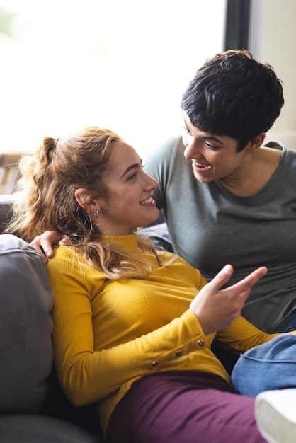 Premium Photo Happy Biracial Lesbian Couple Embracing On Couch And