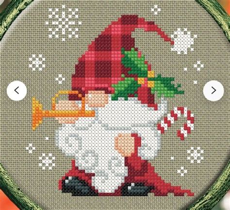 A Cross Stitch Christmas Ornament With A Santa Clause