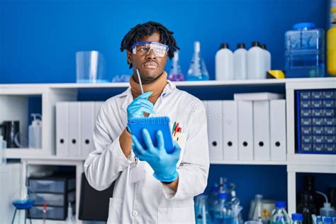 African American Man Scientist Using Touchpad At Laboratory Stock Photo