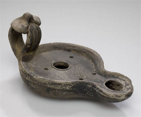 An Old Metal Object With Two Holes In It