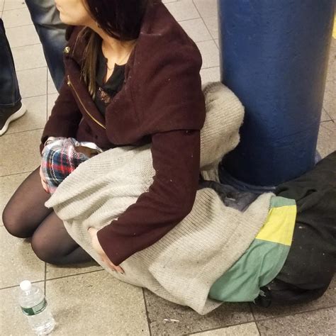 Woman Holds And Comforts A Homeless Man Experiencing Medical And