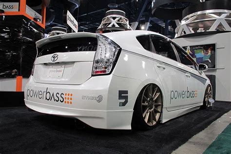 A White Car Is On Display At An Auto Show