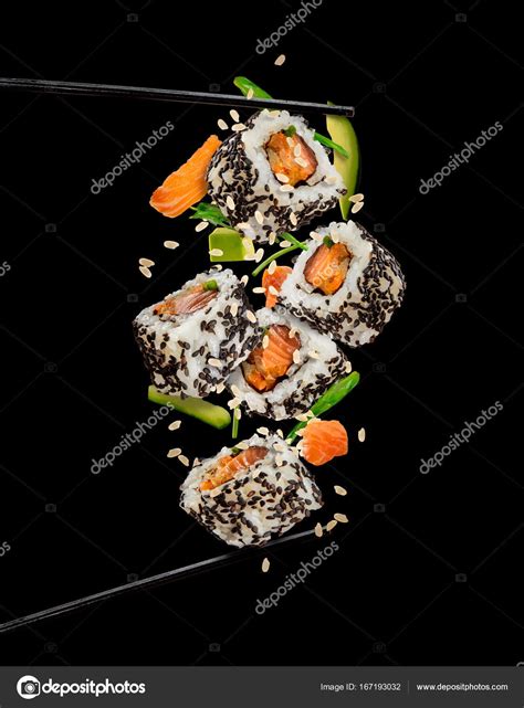 Sushi Pieces Placed Between Chopsticks On Black Background — Stock