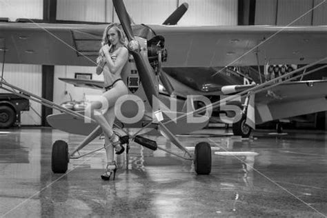 A Gorgeous Blonde Model Poses Topless With A Small General Aircraft Stock Image