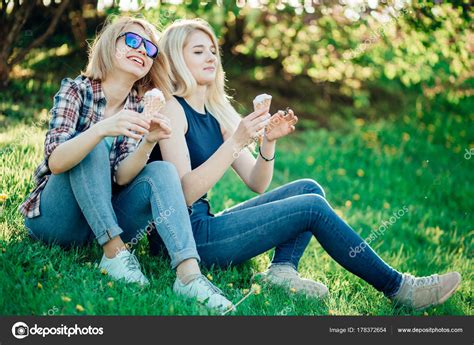 Two Woman Holding Melting Ice Cream Waffle Cone In Hands On Summer