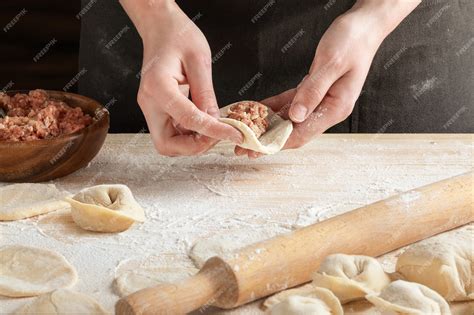 Premium Photo Front View Of Womans Hands Making Meat Dumpling With Wooden Rolling Pin