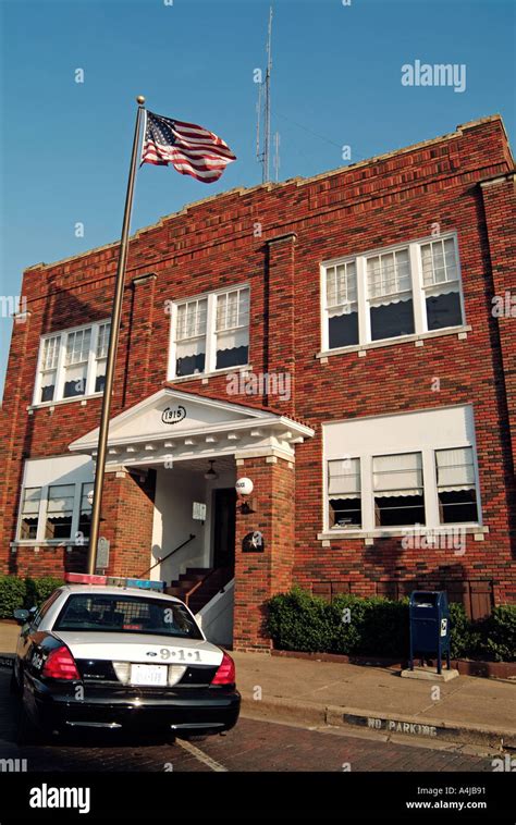 Police Car Parked In Front Of The Police Station Of Ennis Texas Stock