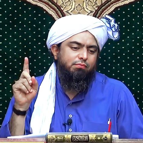 A Man With A White Turban Giving The Peace Sign In Front Of Him