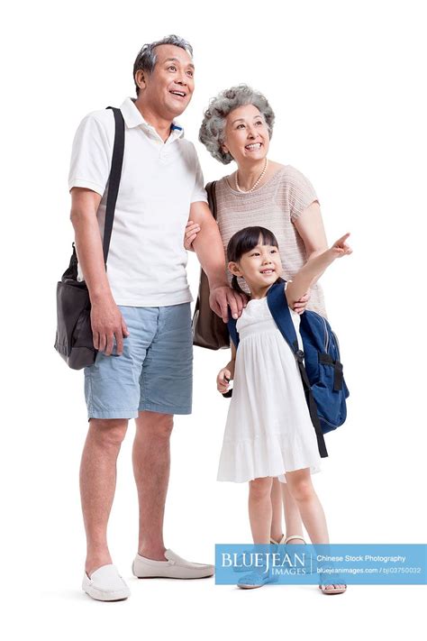 Joyful Chinese Grandparents And Granddaughter Looking At View High Res