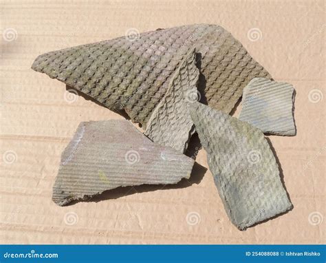 Fragments Of Asbestos Slate For The Roof Of A House Isolated On Bright