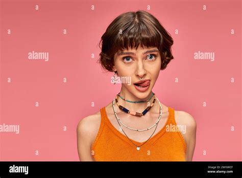 Cheeky Playful Girl In S With Short Brunette Hair Sticking Tongue Out