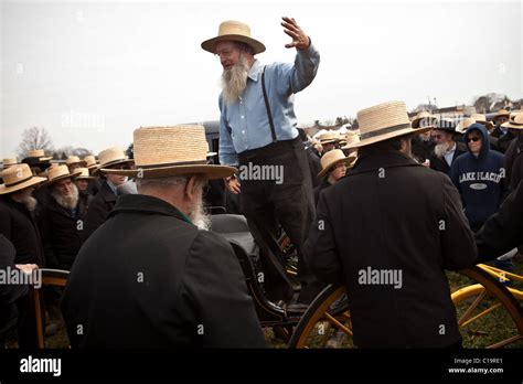 Amish Men Bid On Horse Buggies During The Annual Mud Sale To Support