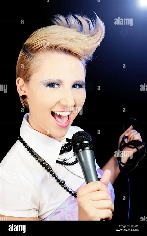 Female singer with special hair cut Stock Photo - Alamy