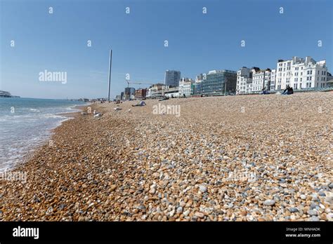 Brighton beach on a sunny day / UK seaside, pebble beach, Brighton seafront. Brighton, East ...