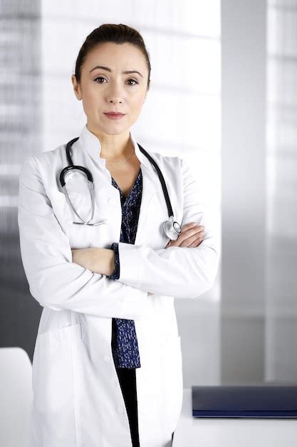 Una Doctora Profesional Sonriente Est De Pie Con Los Brazos Cruzados