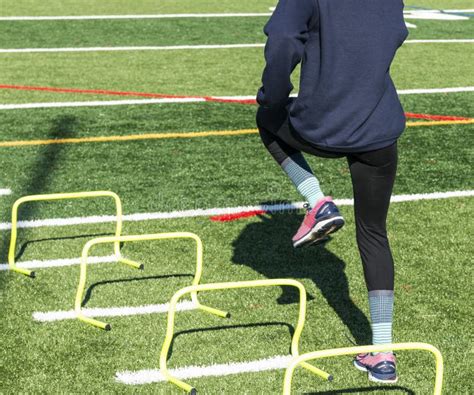 High School Girl Performing Athletic Drills on Turf Stock Image - Image of hurdles, gloves ...