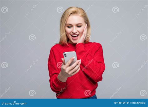 Portrait Amazed Young Girl Looking at Phone Isolated on Gray Wall ...