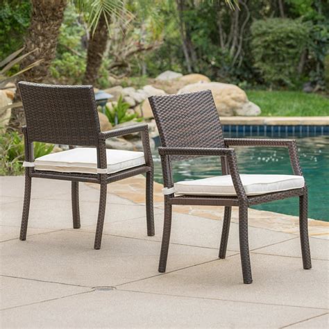 Outdoor Brown Wicker Dining Chairs With White Water Resistant Cushions