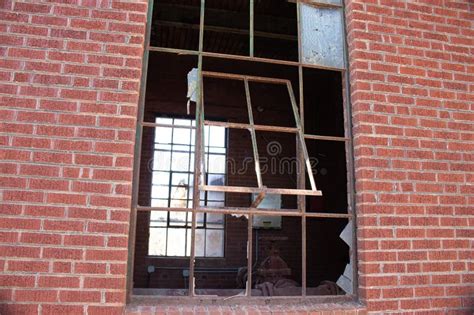 Broken Window In An Old Abandoned Red Brick Building Stock Photo