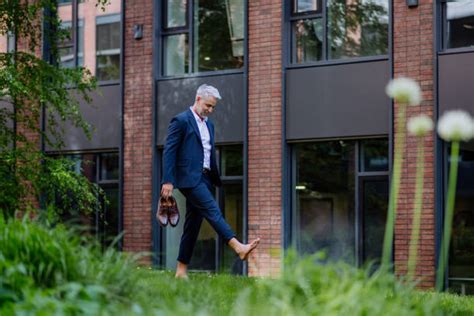 100 Businessman Relaxing In The Grass With His Shoes Off Stock Photos