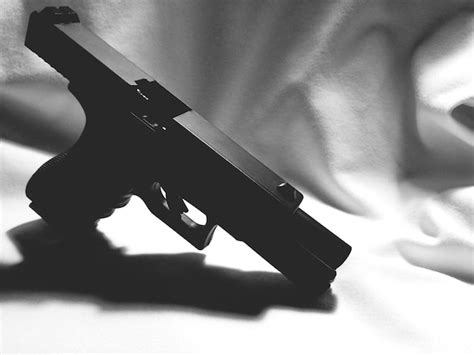 Premium Photo High Angle View Of Gun On Bed