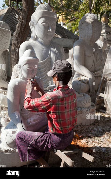 Stone carving workshop in Mandalay, Myanmar- man working on Buddha ...