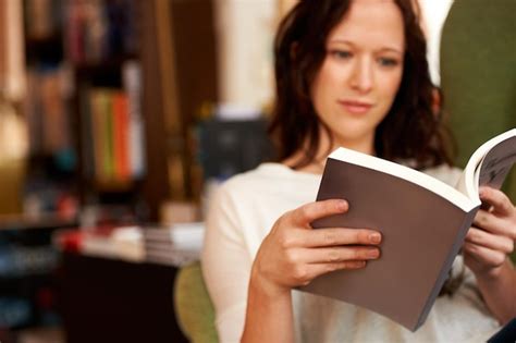 Premium Photo Immersed In The Words A Young Woman Quietly Reading A