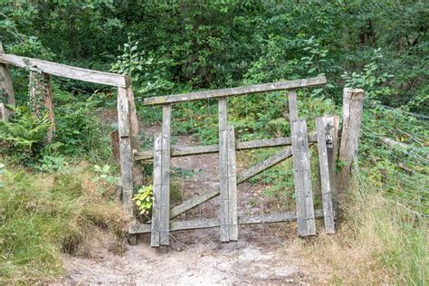 wooden gate in a field with fence 9813782 Stock Photo at Vecteezy