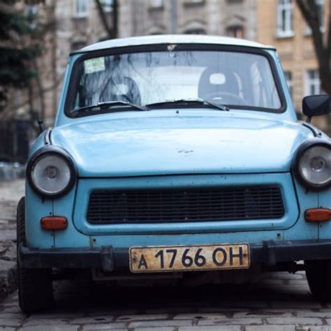 Classic Brown Vehicle Parked Beside Trees · Free Stock Photo