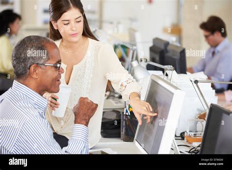 Workers At Desks In Busy Creative Office Stock Photo Alamy