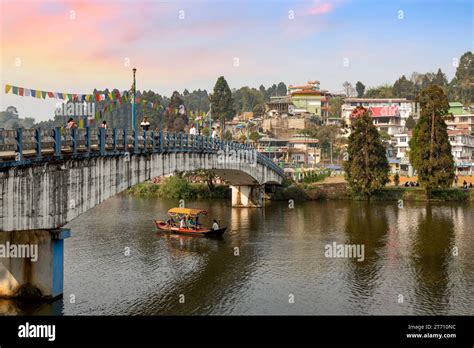 Mirik Lake with its cityscape and view of tourists boating at sunset. Mirik is a popular hill ...