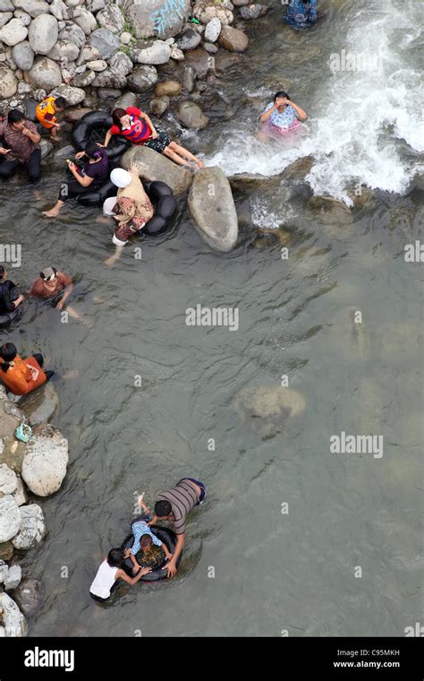 People bathing in the Bohorok River in Bukit Lawang Stock Photo - Alamy