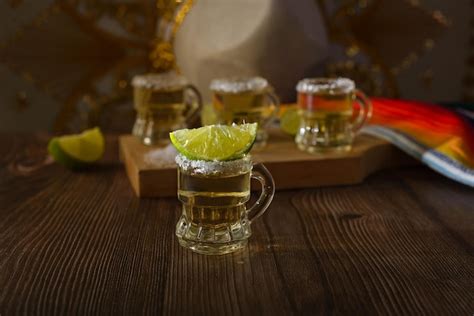 Premium Photo Tequila Shots With Salt And Lime On A Bar Table Shots