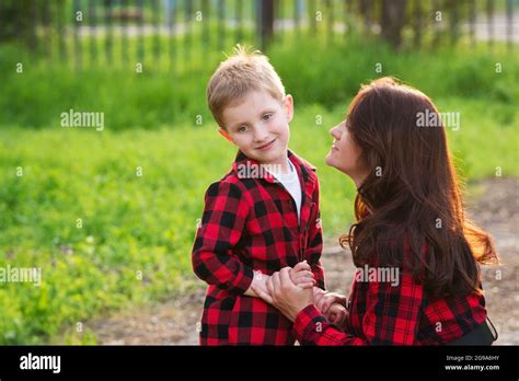 Stylish mom is talking with her naughty son for a walk. Family