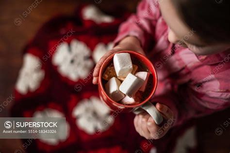 Overhead View Of Girl Driking Hot Cocoa With Marshmallows SuperStock