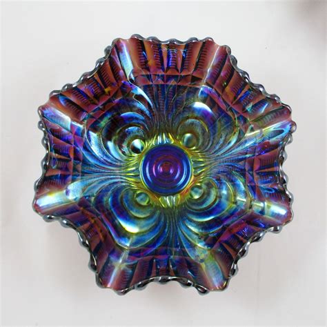 A Colorful Glass Bowl Sitting On Top Of A White Table