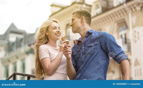 Cheerful Couple Having Fun On Date Eating Sweet Ice Cream Together