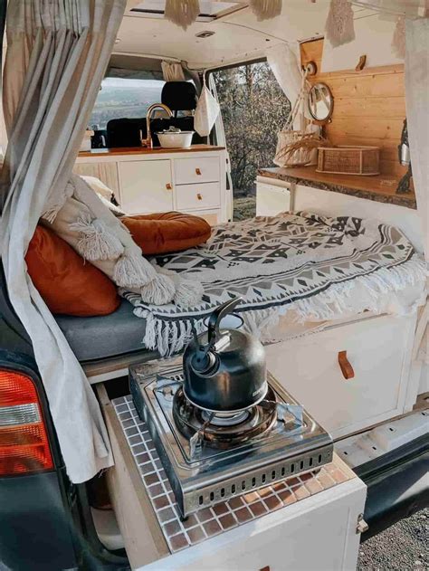 A Camper Van With Its Bed Pulled Up To The Side