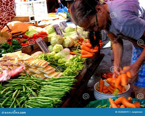 Market Vendor Selling Vegetables In A Market In Philippines Editorial