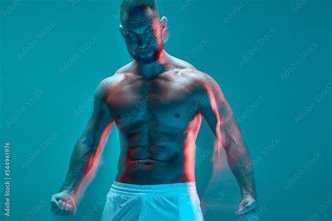Powerful Athletic Man With Muscular Naked Torso Trained Abdominal Muscles Clenches His Fists